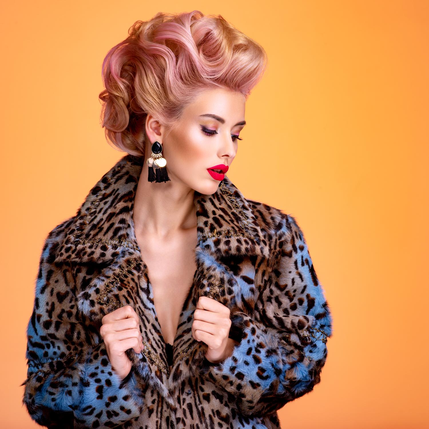 Glamorous model in vintage leopard faux fur coat with retro hairstyle