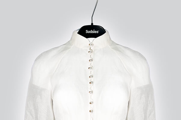 Sheer white Shirt on hanger representing delicate garment cleaning