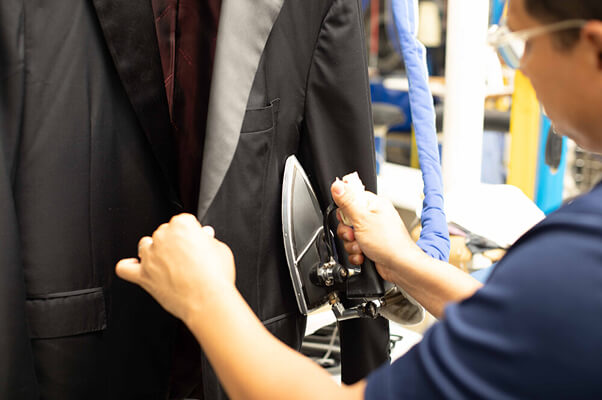 Sudsies expert pressing luxury suit