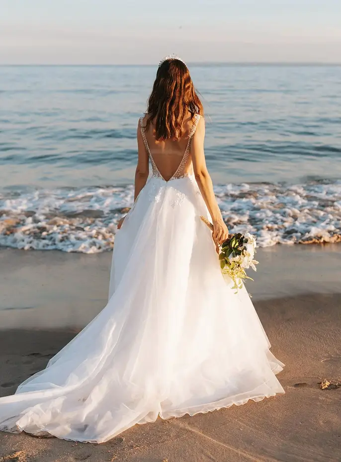 Bride in wedding dress by the sea